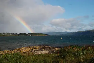 a rainbow over a large body of water at Shieling Holidays Mull in Craignure