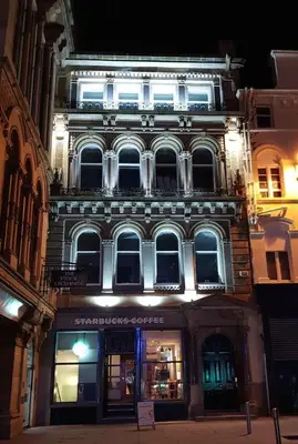 a large building with lights on the side of it at Nelson Mandela Place Apartments in Glasgow
