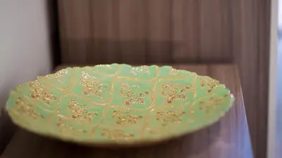 a green plate sitting on top of a table at Snug - Tùr Sealladh Apartment in Helensburgh