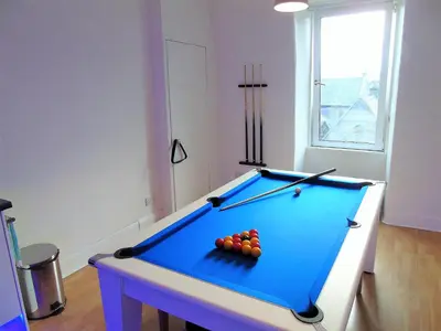 a pool table with balls on it in a room at Snug - Tùr Sealladh Apartment in Helensburgh