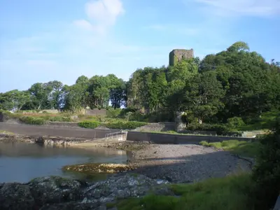a castle sitting on top of a hill next to a river at Gramarvin B&B in Oban