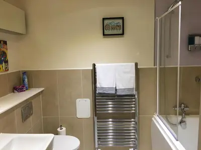 a bathroom with a shower and a sink and a toilet at Marina View Apartment in Inverkip