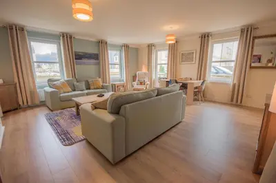 a living room with a couch and a table at Marina View Apartment in Inverkip