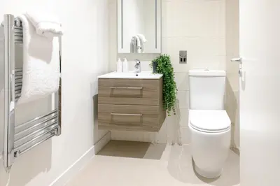 a white bathroom with a toilet and a sink at Heeton Concept Aparthotel Edinburgh Queen Street in Edinburgh