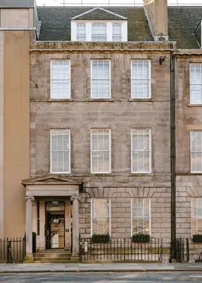 an old brick building with white windows at Heeton Concept Aparthotel Edinburgh Queen Street in Edinburgh