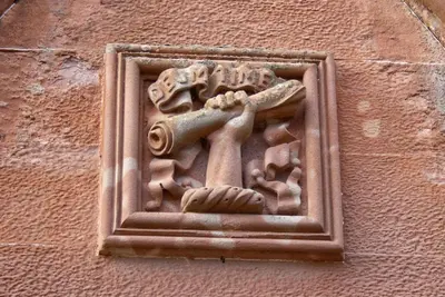 a wall with a carving of a cross on it at Cringletie House in Peebles
