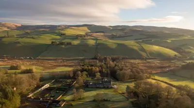 an aerial view of a house in a field at Cringletie House in Peebles