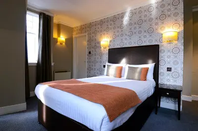 a bedroom with a large bed in a room at Columba Hotel in Oban