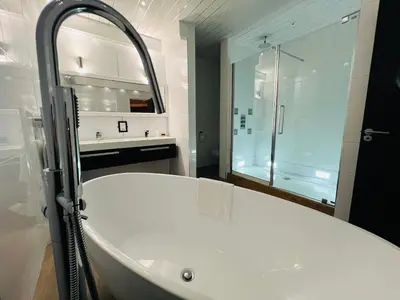 a white bathroom with a tub and a shower at The Popinjay Hotel in Larkhall