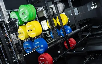 a row of colorful dumbbells in a gym at The Popinjay Hotel in Larkhall