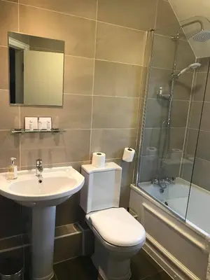 a bathroom with a toilet and a sink and a shower at Bridge of Orchy Hotel in Bridge of Orchy