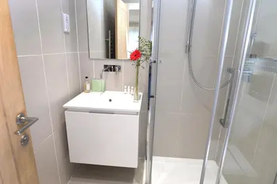 a bathroom with a white sink and a shower at Bridge of Orchy Hotel in Bridge of Orchy