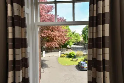 an open window with a view of a yard at Savoy Park Hotel in Ayr