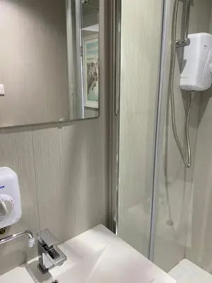 a bathroom with a shower and a sink at Marina Studio in Irvine