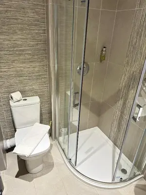 a bathroom with a shower and a toilet at Hill Park Hotel in Rosyth