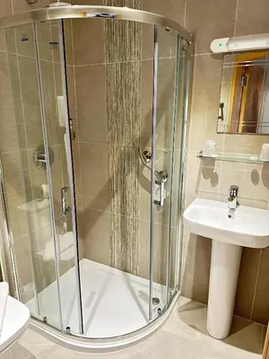 a bathroom with a shower and a sink at Hill Park Hotel in Rosyth