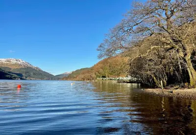 a view of a lake with mountains in the background at Deer Croft Lodge in Hunters Quay