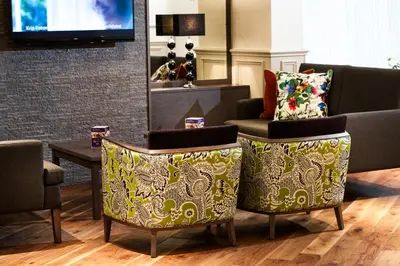 a living room with two chairs and a table at Leonardo Inn Glasgow West End in Glasgow