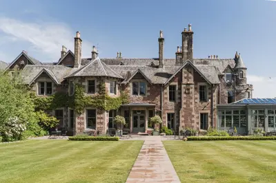 a large stone house with a lawn in front of it at Cromlix in Kinbuck