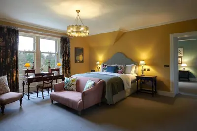 a bedroom with a bed and a table and chairs at Cromlix in Kinbuck