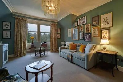 a living room with a couch and a table at Cromlix in Kinbuck