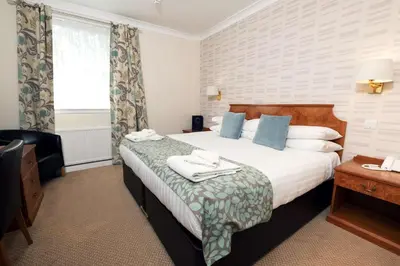 a hotel room with a bed and a window at Pitbauchlie House Hotel - Sure Hotel Collection by Best Western in Dunfermline