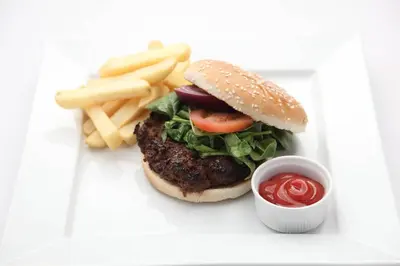 a hamburger and french fries and a cup of ketchup at Argyll Hotel in Dunoon