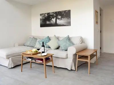 a living room with a couch and a table at Rowanlea in Muthill
