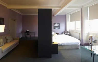 a bedroom with a bed and a couch at B+B Edinburgh in Edinburgh