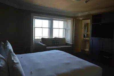 a bedroom with a bed and a couch and a window at B+B Edinburgh in Edinburgh