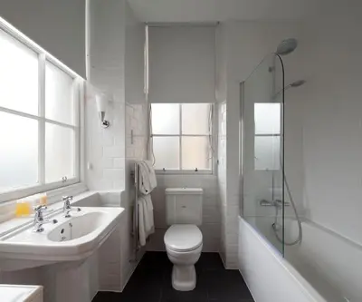 a bathroom with a toilet and a sink and a shower at B+B Edinburgh in Edinburgh