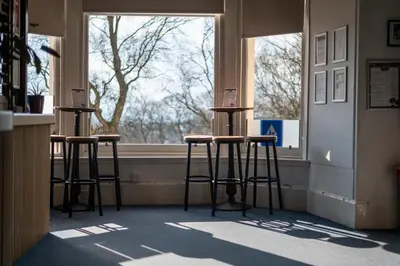 a room with three stools in front of a window at Glasgow Youth Hostel in Glasgow