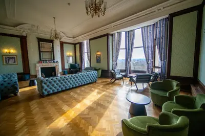 a living room with a couch and chairs and a fireplace at Glasgow Youth Hostel in Glasgow
