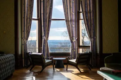a room with two chairs and a large window at Glasgow Youth Hostel in Glasgow
