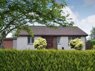 a house with bushes in front of it at Achnaha in Ardentinny