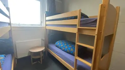 a room with two bunk beds and a stool at Stirling Youth Hostel in Stirling