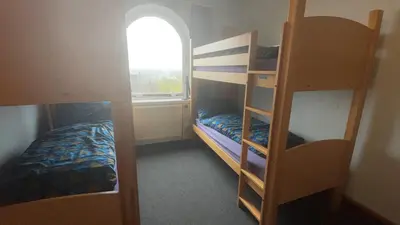a room with two bunk beds and a window at Stirling Youth Hostel in Stirling