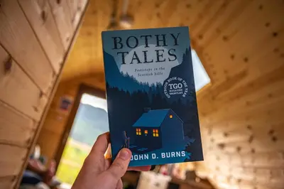 a person holding a book in their hand at Glencoe Youth Hostel in Ballachulish