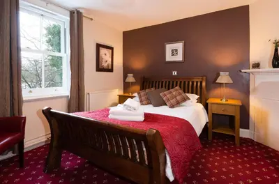 a bedroom with a bed with towels on it at Killin Hotel in Killin