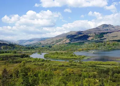 a view of a river with mountains in the background at Killin Hotel in Killin