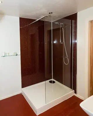 a shower with a glass enclosure in a bathroom at Killin Hotel in Killin