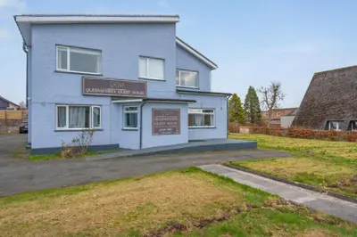 a blue house with a sign in front of it at Queensferry Guest house in Rosyth