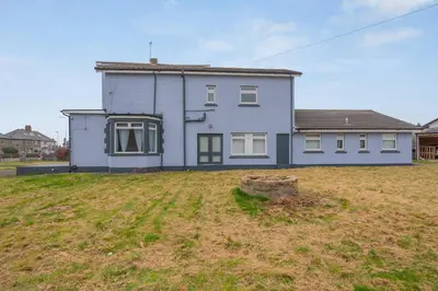 a white house with a yard in front of it at Queensferry Guest house in Rosyth