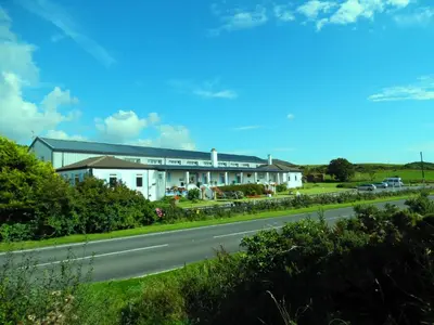 a large white building on the side of a road at Rhins of Galloway in Cairnryan