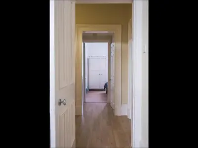a hallway with an open door and a hallway with a hallwayngthngthngthngth at Cedar Apartment in Helensburgh