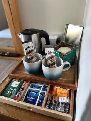a shelf with two bowls of tea and cups on it at Beaches in Ayr
