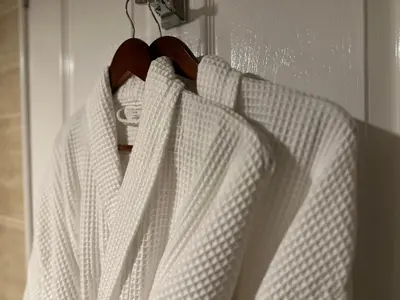 a white robe is hanging on a door at Beaches in Ayr