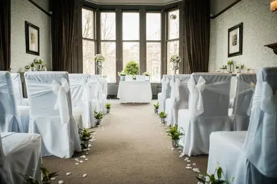 a wedding aisle with white chairs and tables at One Devonshire Gardens a Hotel Du Vin in Glasgow