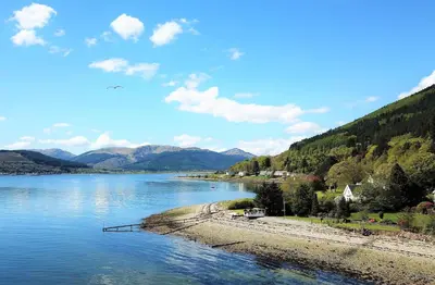 a view of a river with mountains in the background at Dunbheag Cottage in Strone