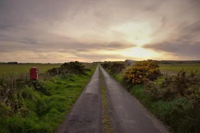 a dirt road in the middle of a field at Oban Youth Hostel in Oban